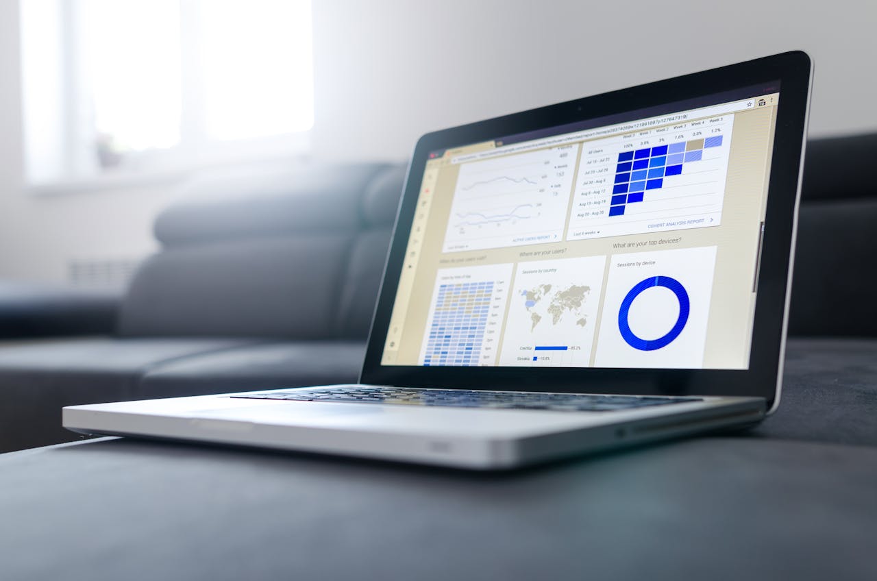 about-us Sleek laptop showcasing data analytics and graphs on the screen in a bright room.